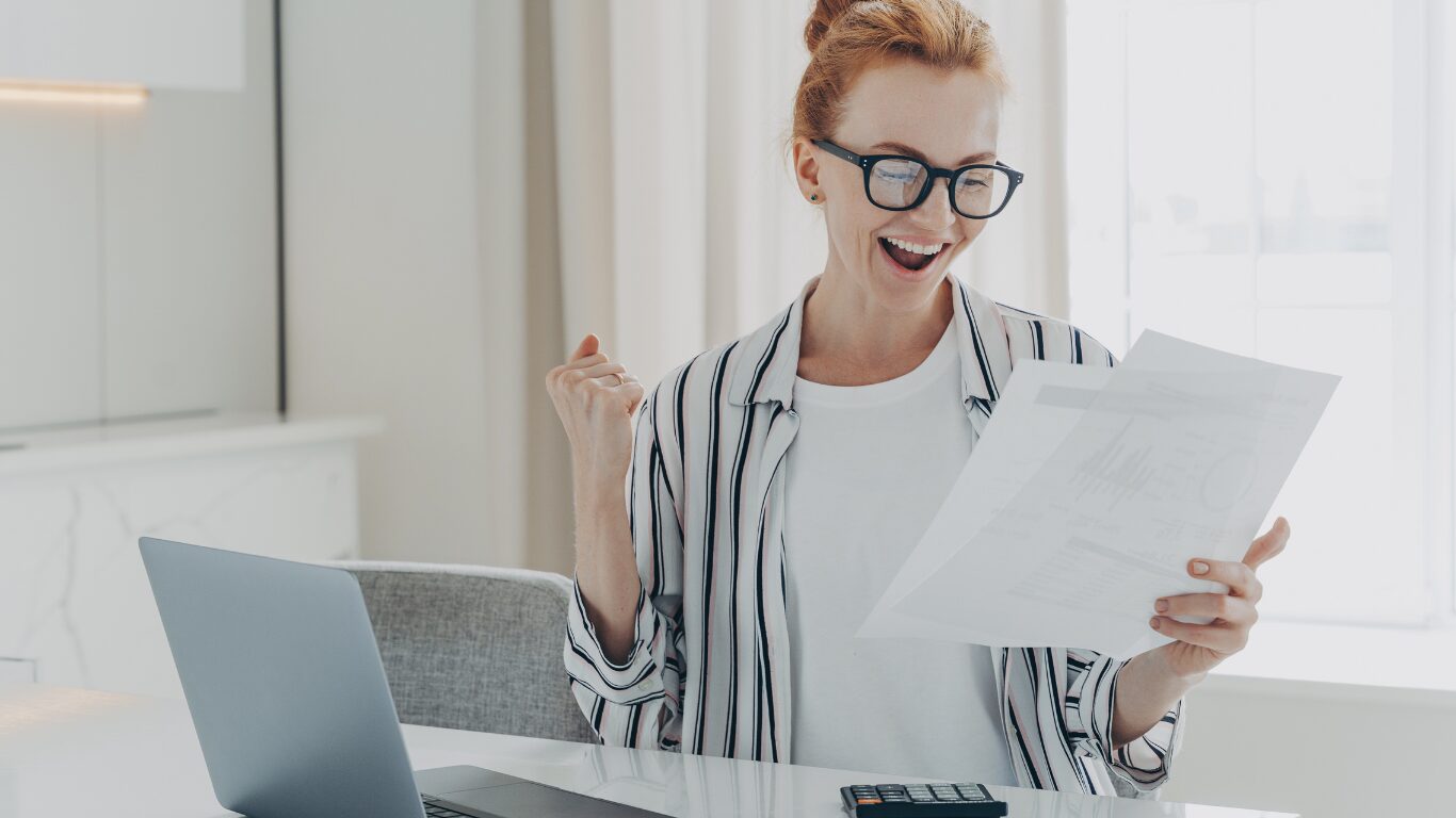 Business owner reviewing financial reports while assessing company value.